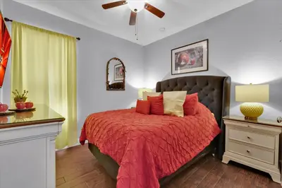 a bedroom with a bed with a red comforter at 7752 Tosteth in Kissimmee