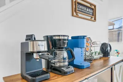 a kitchen counter with a coffee maker on it at Beautiful 5BR 4 baths Themed home near Disney and Universal, Private Pool, Gameroom, baby Crib and more in Kissimmee