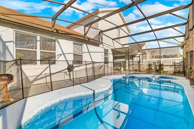 an indoor swimming pool with a glass roof at Beautiful 5BR 4 baths Themed home near Disney and Universal, Private Pool, Gameroom, baby Crib and more in Kissimmee