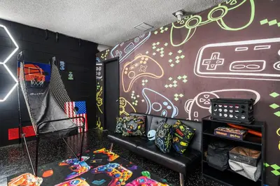 a room with a wall covered in graffiti at Beautiful 5BR 4 baths Themed home near Disney and Universal, Private Pool, Gameroom, baby Crib and more in Kissimmee
