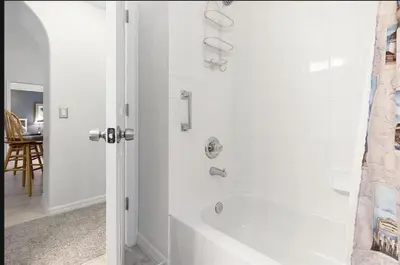 a white bathroom with a tub and a shower at Tropical Escape by Shine Villas 244 villa in Kissimmee