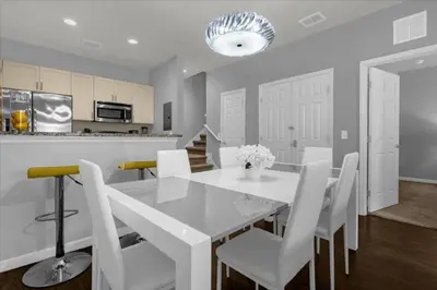 a kitchen and dining room with a white table and chairs at 3 Bedrooms 2 Bathrooms Lucaya Village 13-107 in Kissimmee