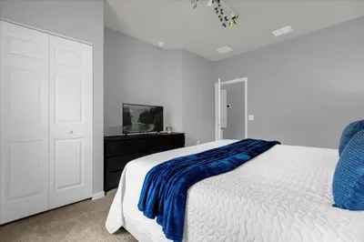 a bedroom with a bed with a blue blanket on it at 3 Bedrooms 2 Bathrooms Lucaya Village 13-107 in Kissimmee