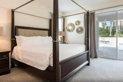 a bedroom with a canopy bed and a balcony at 361 Pendant ct in Orlando