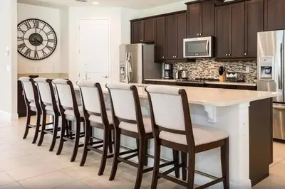 a kitchen with a bar with a row of chairs at 361 Pendant ct in Orlando