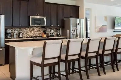 a kitchen with a bar with chairs around it at 361 Pendant ct in Orlando