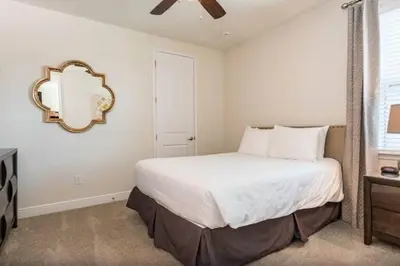 a bedroom with a bed and a mirror on the wall at 361 Pendant ct in Orlando