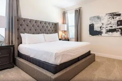 a bedroom with a large bed with a large headboard at 361 Pendant ct in Orlando