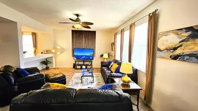 a living room with a couch and a tv at Bluelakeview Luxury Villa with Private Pool & Spa plus Lake Views, BBQ, Games Room in Orlando