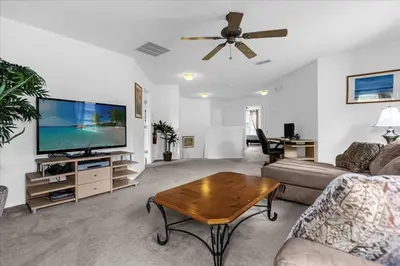 a living room with a couch and a tv at Bluelakeview Luxury Villa with Private Pool & Spa plus Lake Views, BBQ, Games Room in Orlando