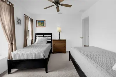 a bedroom with two beds and a ceiling fan at Bluelakeview Luxury Villa with Private Pool & Spa plus Lake Views, BBQ, Games Room in Orlando