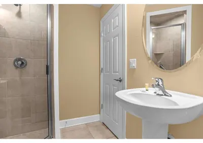 a bathroom with a sink and a shower with a mirror at Your Summer Getaway Awaits - Townhome by Disney! in Orlando