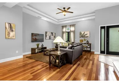 a living room with a couch and a ceiling fan at Your Summer Getaway Awaits - Townhome by Disney! in Orlando
