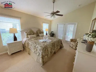 a bedroom with a bed and a ceiling fan at 35 - Relax & Play 4-Bed Villa with Pool & Game Room Minutes to Disney in Orlando