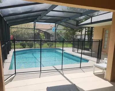 a swimming pool in a house with an open patio at 35 - Relax & Play 4-Bed Villa with Pool & Game Room Minutes to Disney in Orlando