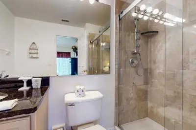 a bathroom with a shower and a toilet and a sink at Disney 15 Min - Sleeps 8 - Private Pool in Kissimmee