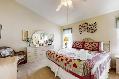 a bedroom with a bed and a dresser and a mirror at Disney 15 Min - Sleeps 8 - Private Pool in Kissimmee