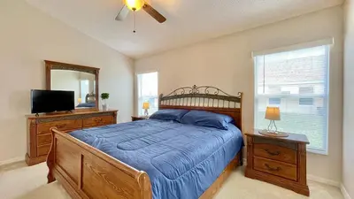 a bedroom with a bed and a television and a mirror at The Oasis in Orlando