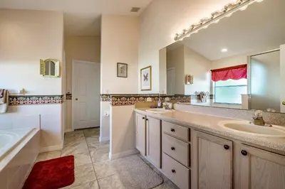 a bathroom with two sinks and a large mirror at The Oasis in Orlando