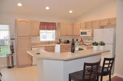 a kitchen with a white refrigerator and a counter top at The Oasis in Orlando