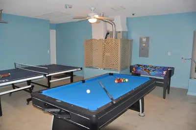 a room with two ping pong tables and a ball at The Oasis in Orlando