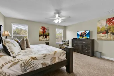 a bedroom with a bed and a flat screen tv at 2920 Banana Palm in Kissimmee