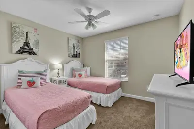a bedroom with two beds and a ceiling fan at 2920 Banana Palm in Kissimmee