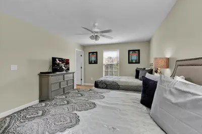a bedroom with two beds and a ceiling fan at 2920 Banana Palm in Kissimmee