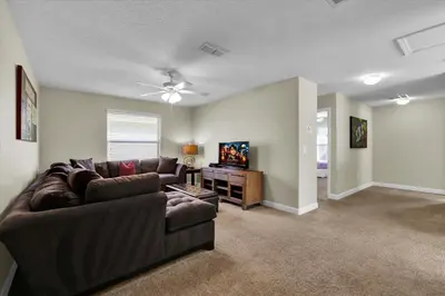a living room with a couch and a flat screen tv at 2920 Banana Palm in Kissimmee