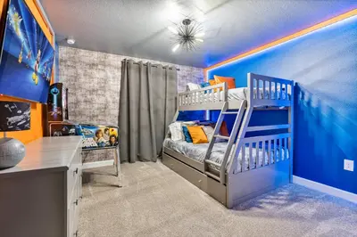 a room with a bed and a desk in it at New Home 4 Bedrooms 3 Bathrooms At Storey Lake in Kissimmee