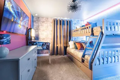 a bedroom with a bed and a bunk bed at New Home 4 Bedrooms 3 Bathrooms At Storey Lake in Kissimmee