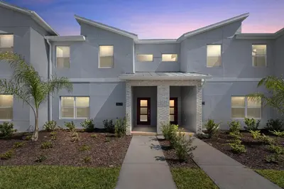 a rendering of the front of a house at New Home 4 Bedrooms 3 Bathrooms At Storey Lake in Kissimmee