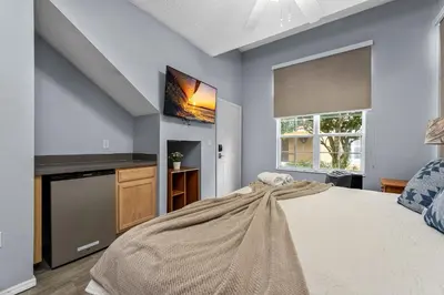 a bedroom with a large bed and a flat screen tv at Near Disney + FREE Clubhouse + Pool + GYM + Sauna in Kissimmee