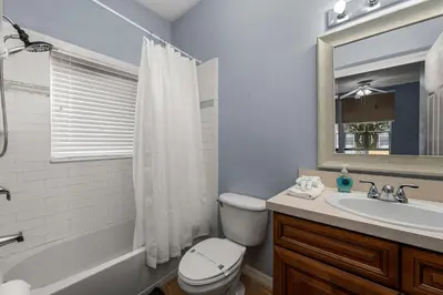 a bathroom with a toilet and a sink and a mirror at Near Disney + FREE Clubhouse + Pool + GYM + Sauna in Kissimmee