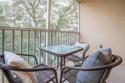 a balcony with a table and chairs and a window at Windsor Palms Gem: Stylish and Fully Equipped in Kissimmee