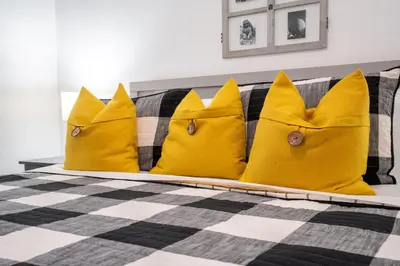 a bed with three yellow pillows on it at Windsor Palms Gem: Stylish and Fully Equipped in Kissimmee