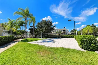 a sandy path in a park with palm trees at Windsor Palms Gem: Stylish and Fully Equipped in Kissimmee