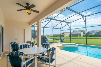 a dining room with a table and chairs and a pool at Sweet Memories in Kissimmee