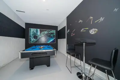 a room with a pool table and stools in it at 4156DS VILLA 5 BED/5 BA in Kissimmee
