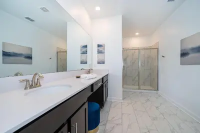 a bathroom with a sink and a shower at 4156DS VILLA 5 BED/5 BA in Kissimmee