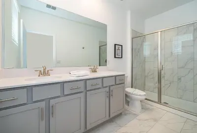 a bathroom with a toilet and a sink and a shower at 4176SS STOREY LAKE VILLA WITH PRIVATE POOL in Kissimmee