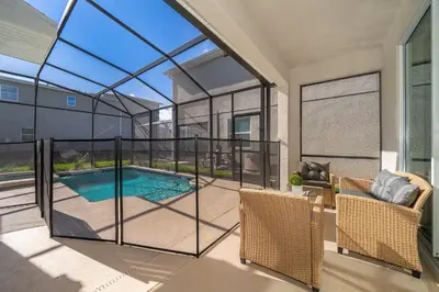 a screened in porch with a swimming pool in a house at 4338JC VILLA 5 BED/5 BA (SANITIZED) in Kissimmee