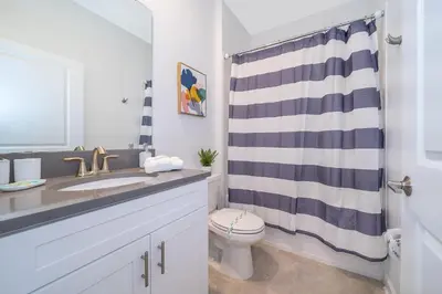 a bathroom with a sink and a toilet and a shower at 4338JC VILLA 5 BED/5 BA (SANITIZED) in Kissimmee