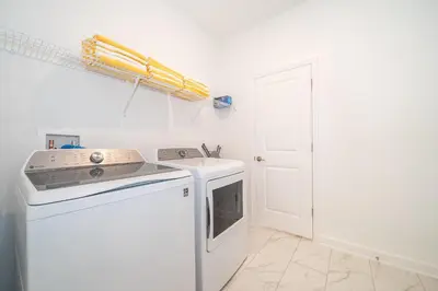 a kitchen with a stove and a white dishwasher at 2668DR VILLA 5 BED/5 BA (SANITIZED) in Kissimmee