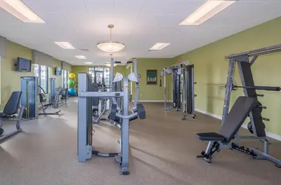 a gym with several tread machines in a room at 2668DR VILLA 5 BED/5 BA (SANITIZED) in Kissimmee