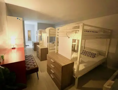 a room with two bunk beds and a room with a desk at Bposhtels Orlando Disney in Kissimmee