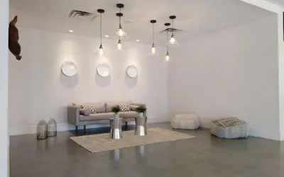 a living room with a couch and four mirrors on the wall at Bposhtels Orlando Disney in Kissimmee