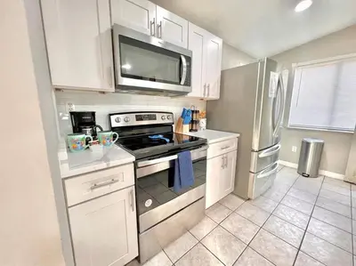 a kitchen with a stove and a refrigerator at Quiet home in Metrowest in Orlando