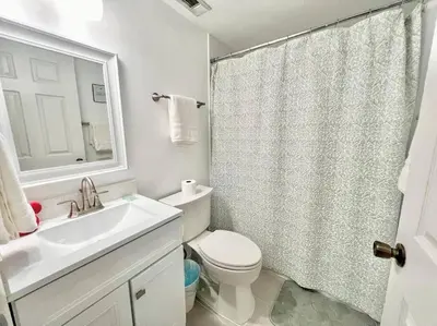 a bathroom with a sink and a toilet and a shower at Quiet home in Metrowest in Orlando