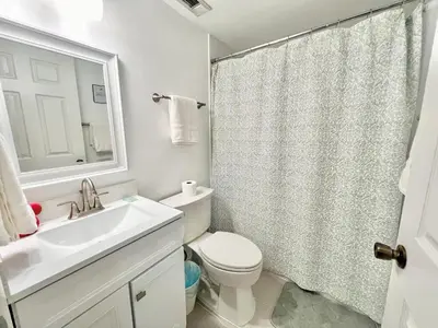 a bathroom with a sink and a toilet and a shower at Quiet home in Metrowest in Orlando